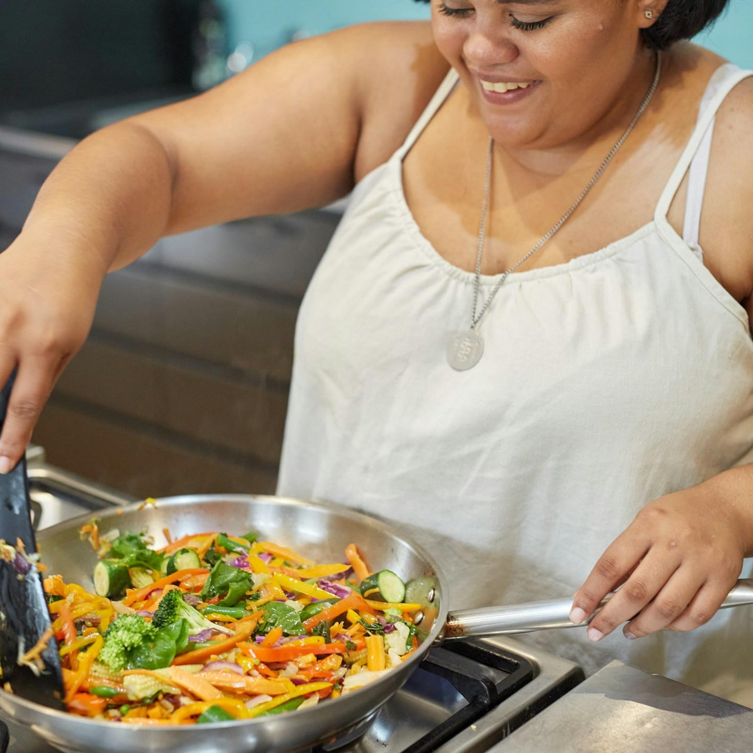Diverse group of community members sharing a meal together, showcasing the social bonds formed through collaborative cooking